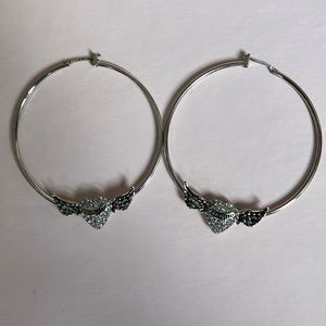 Never been worn silver Juicy Couture hoop earrings.